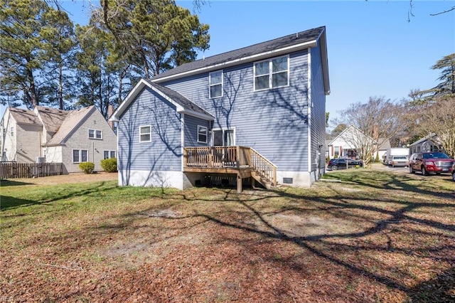 back of house featuring a lawn, a deck, and fence