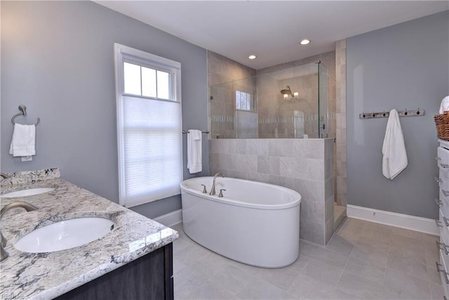 bathroom featuring double vanity, a sink, and tiled shower