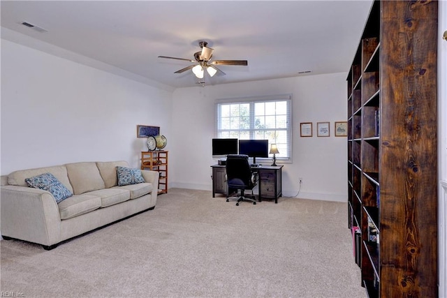 carpeted office with ceiling fan, visible vents, and baseboards