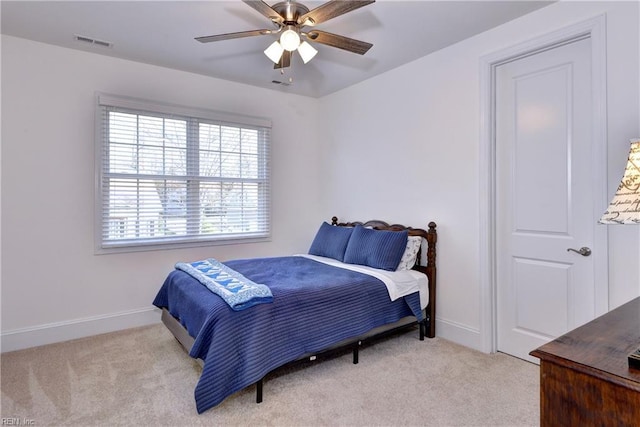 bedroom featuring light colored carpet, visible vents, and baseboards