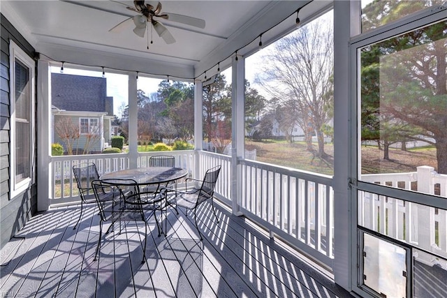 sunroom / solarium with a ceiling fan