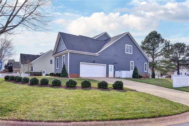 view of home's exterior with aphalt driveway, fence, and a lawn