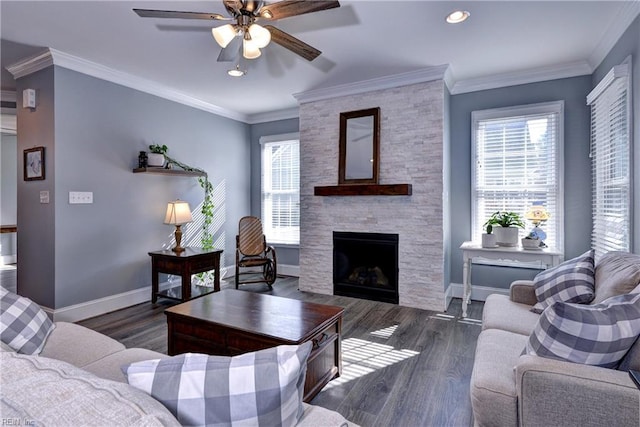 living room with ornamental molding, wood finished floors, a wealth of natural light, and baseboards