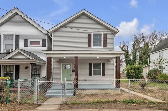 view of front of home featuring a fenced front yard, a gate, and a porch