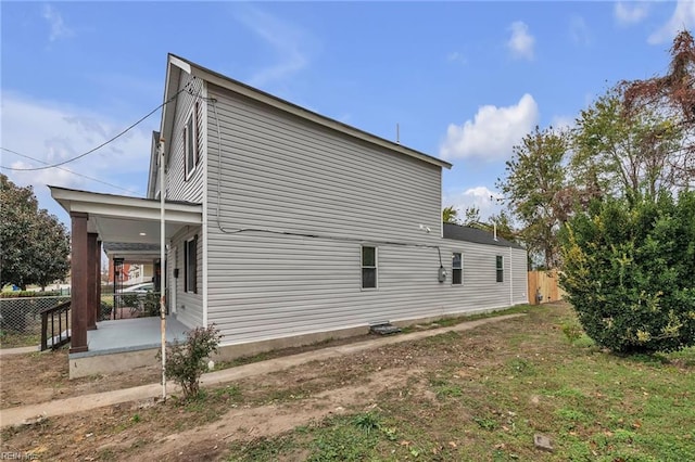 view of side of home with fence