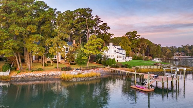 dock area featuring a yard and a water view