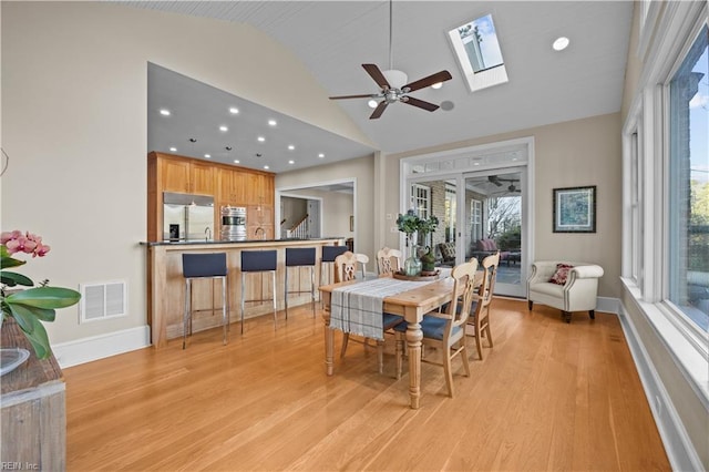 dining space featuring light wood finished floors, visible vents, and plenty of natural light