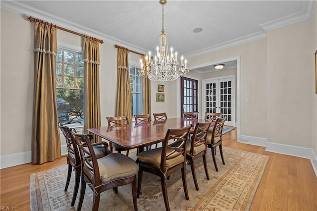 dining area featuring french doors, light wood-type flooring, baseboards, and ornamental molding