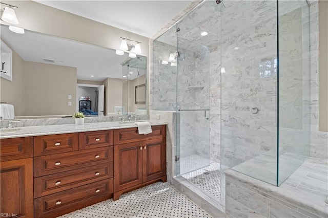 bathroom with visible vents, a shower stall, and double vanity