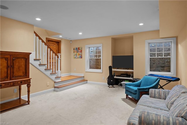 carpeted living area featuring recessed lighting, baseboards, and stairs