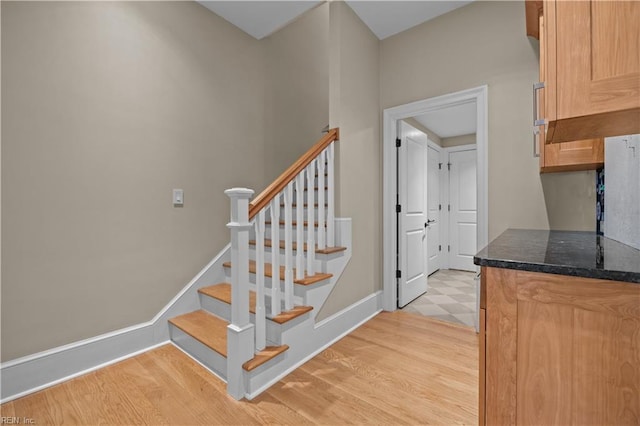 stairway with baseboards and wood finished floors