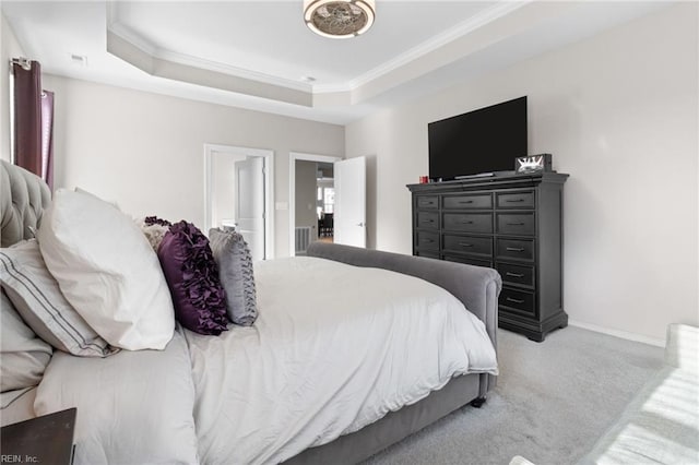 bedroom featuring light carpet, visible vents, baseboards, a raised ceiling, and crown molding