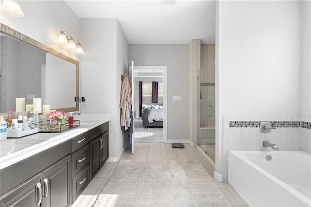 full bathroom with double vanity, a stall shower, a bath, ensuite bathroom, and a sink