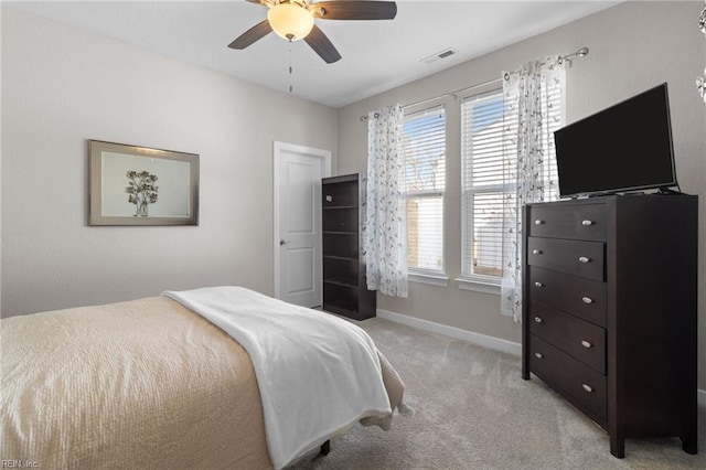 bedroom with light carpet, baseboards, visible vents, and ceiling fan