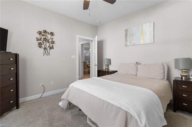 bedroom featuring light carpet, a ceiling fan, and baseboards