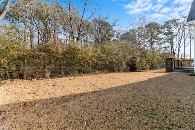 view of yard featuring fence and a wooden deck