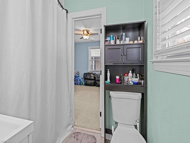 full bath featuring a ceiling fan and toilet