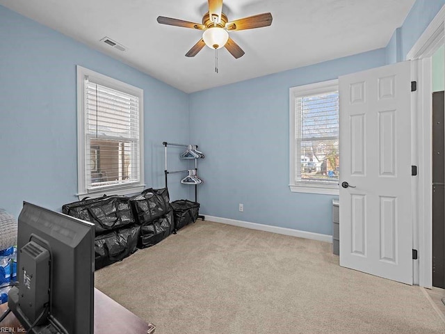 sitting room featuring carpet floors, baseboards, visible vents, and a ceiling fan