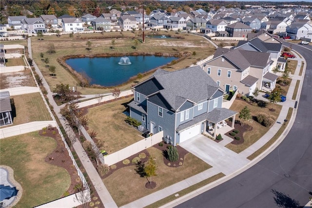 drone / aerial view with a water view and a residential view