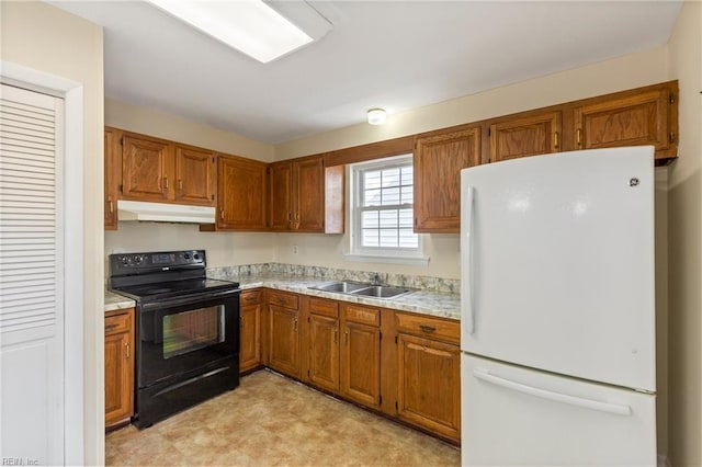 kitchen featuring under cabinet range hood, black range with electric stovetop, a sink, light countertops, and freestanding refrigerator