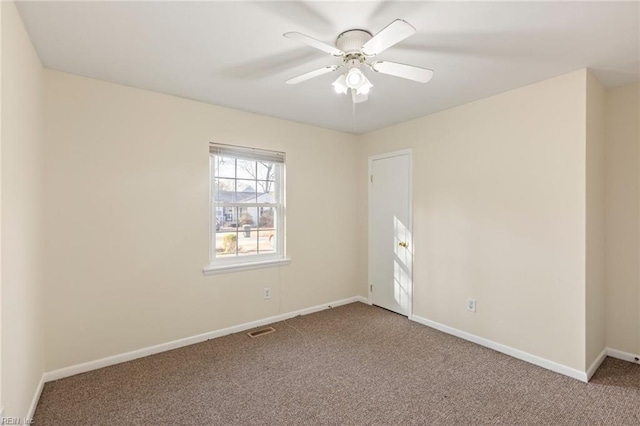 unfurnished room with a ceiling fan, baseboards, visible vents, and carpet flooring