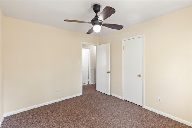 unfurnished bedroom with a ceiling fan, carpet flooring, visible vents, and baseboards