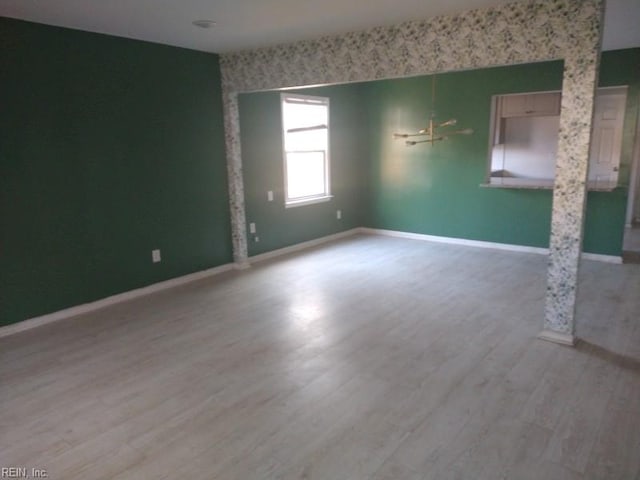 unfurnished room featuring light wood-style floors and baseboards