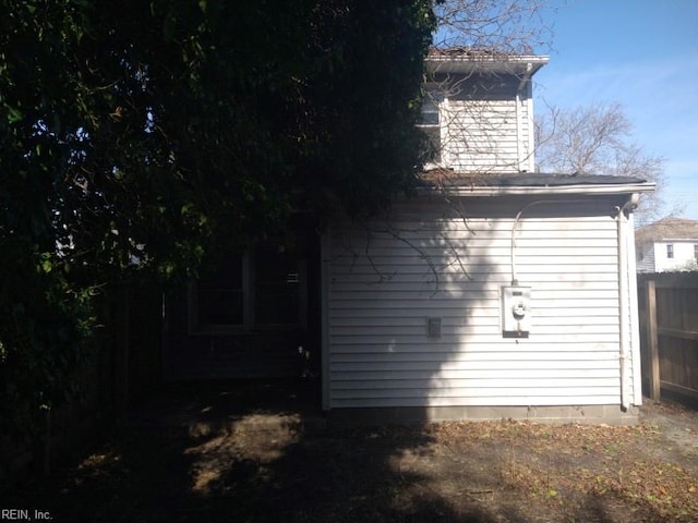 rear view of house featuring fence