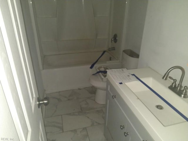 full bath with toilet, marble finish floor, bathtub / shower combination, and vanity