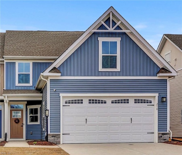 view of front of house featuring a garage, board and batten siding, and driveway