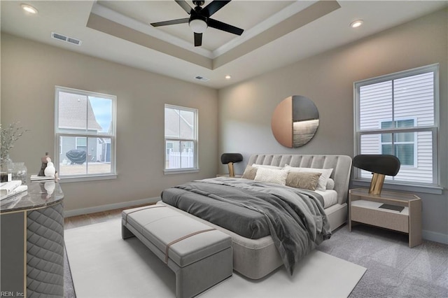 bedroom with recessed lighting, visible vents, a raised ceiling, and baseboards