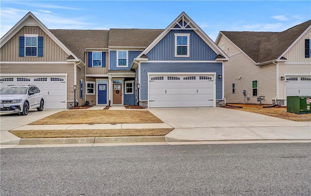 view of front of house with an attached garage, board and batten siding, driveway, and roof with shingles