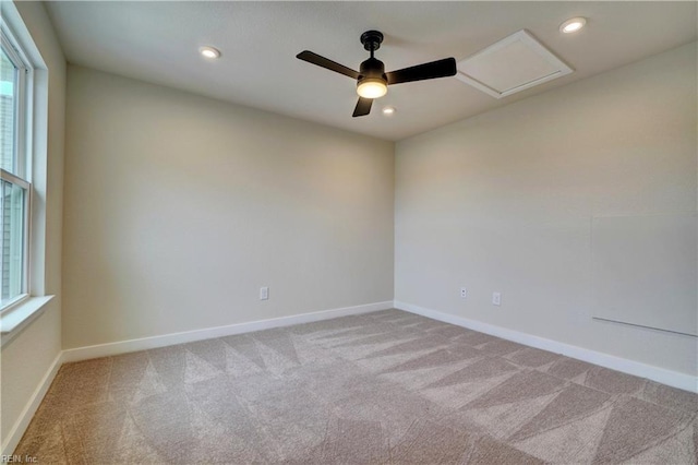 carpeted empty room featuring recessed lighting, baseboards, and attic access