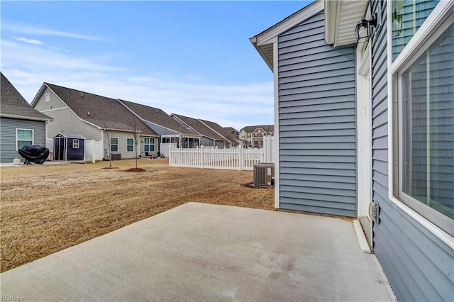 view of patio featuring fence and a residential view