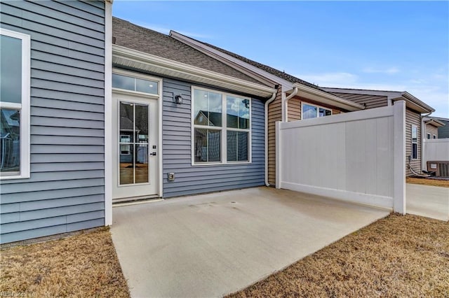 view of patio featuring central AC and fence