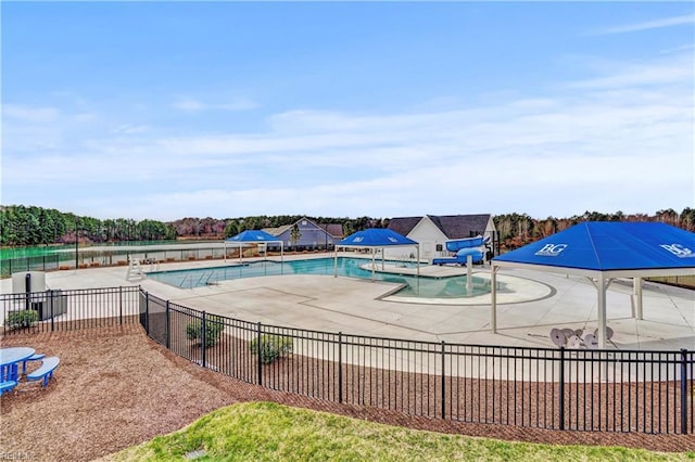 pool featuring a patio area and fence