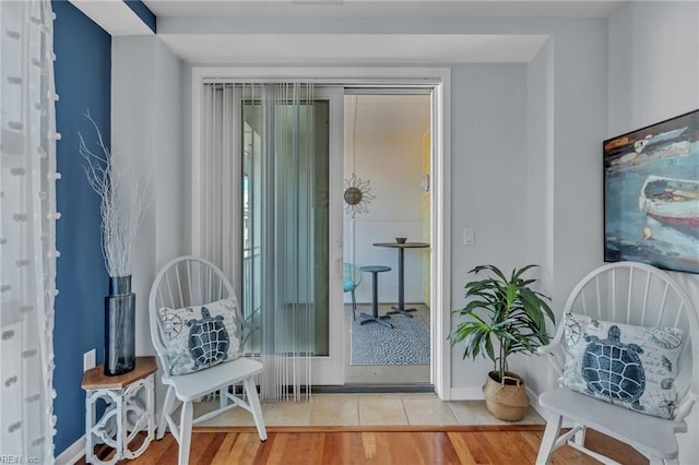 living area featuring baseboards and wood finished floors