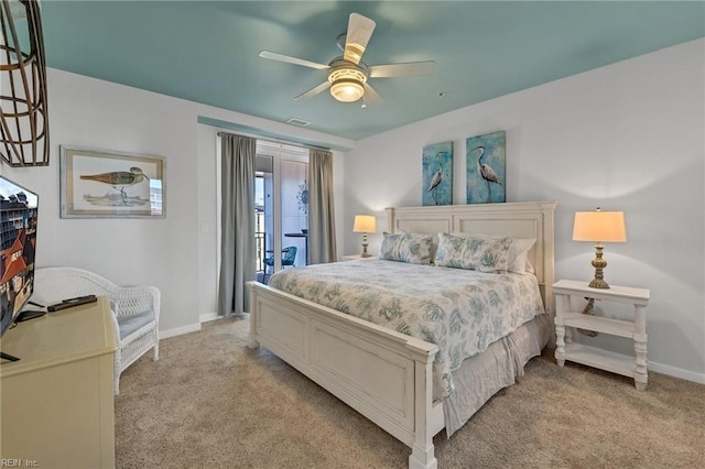 bedroom with access to exterior, light colored carpet, visible vents, and baseboards