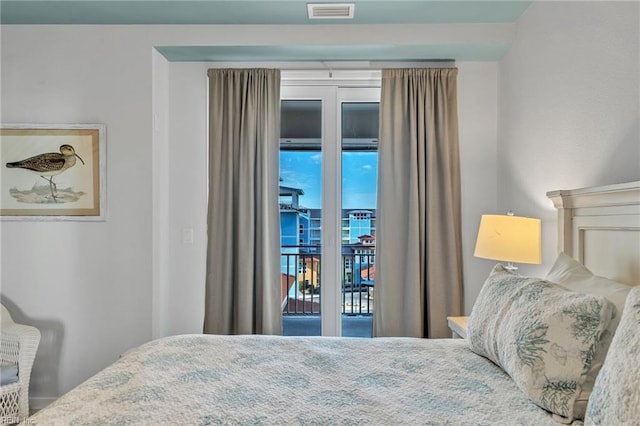 bedroom featuring access to outside and visible vents