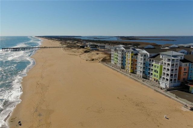 aerial view with a water view and a beach view