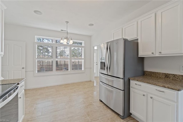 kitchen featuring white cabinets, dark stone countertops, stainless steel appliances, a chandelier, and pendant lighting