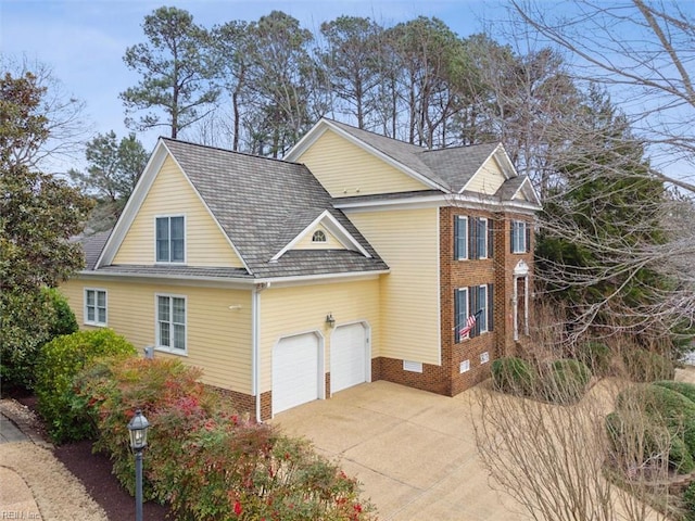 view of side of property featuring driveway and brick siding