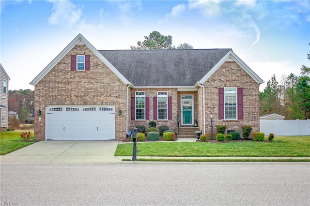 view of front of house with brick siding, driveway, a front yard, and fence