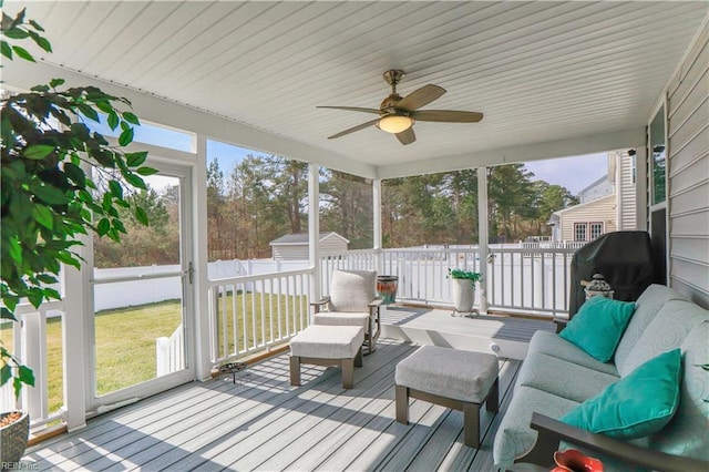 sunroom / solarium featuring ceiling fan