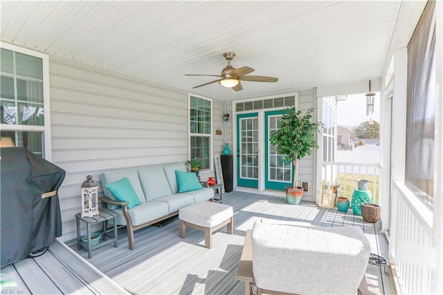 wooden deck with area for grilling, an outdoor living space, and ceiling fan