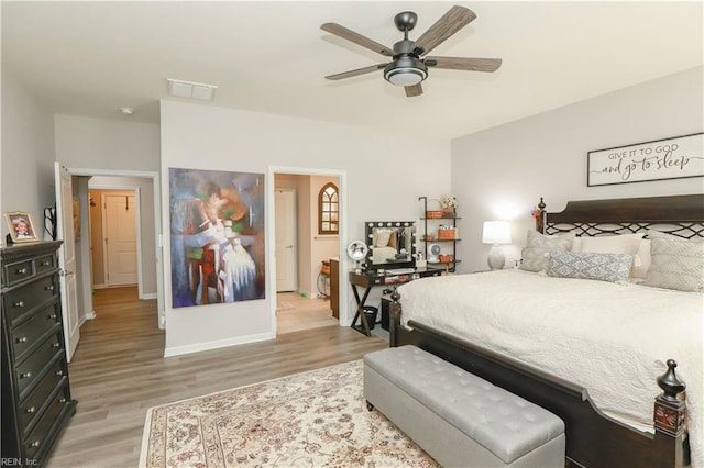 bedroom featuring visible vents, a ceiling fan, light wood-type flooring, and baseboards