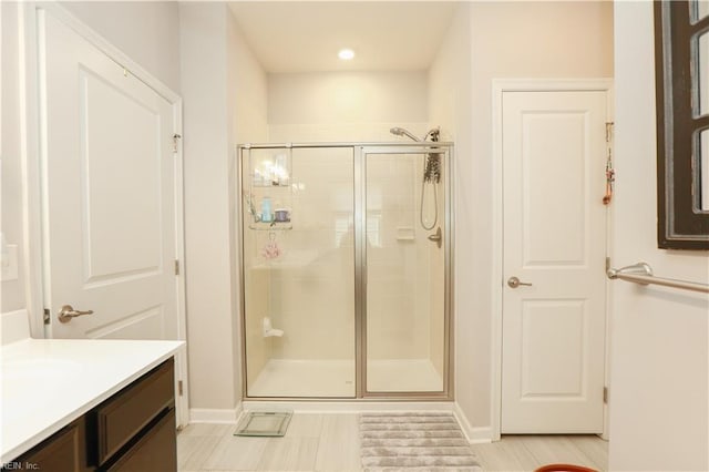 full bathroom featuring vanity and a shower stall