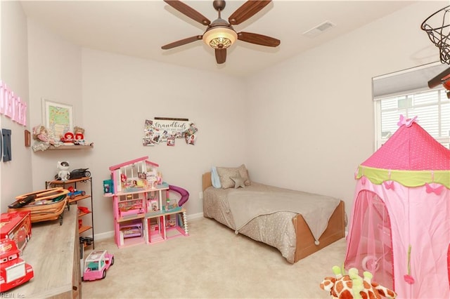 carpeted bedroom with a ceiling fan, visible vents, and baseboards