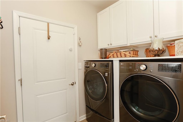 washroom with washer and dryer and cabinet space