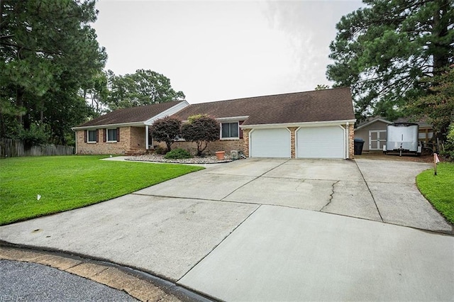 single story home with a garage, a front lawn, concrete driveway, and brick siding